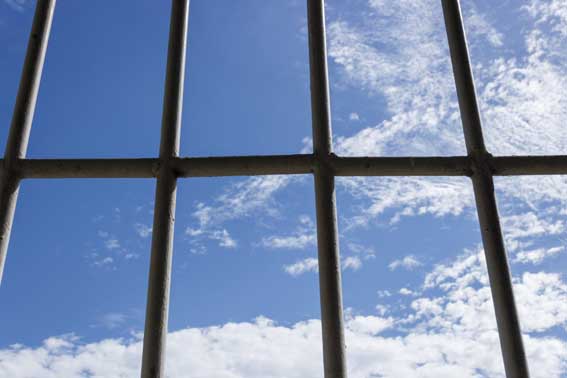 Prison bars and blue sky
